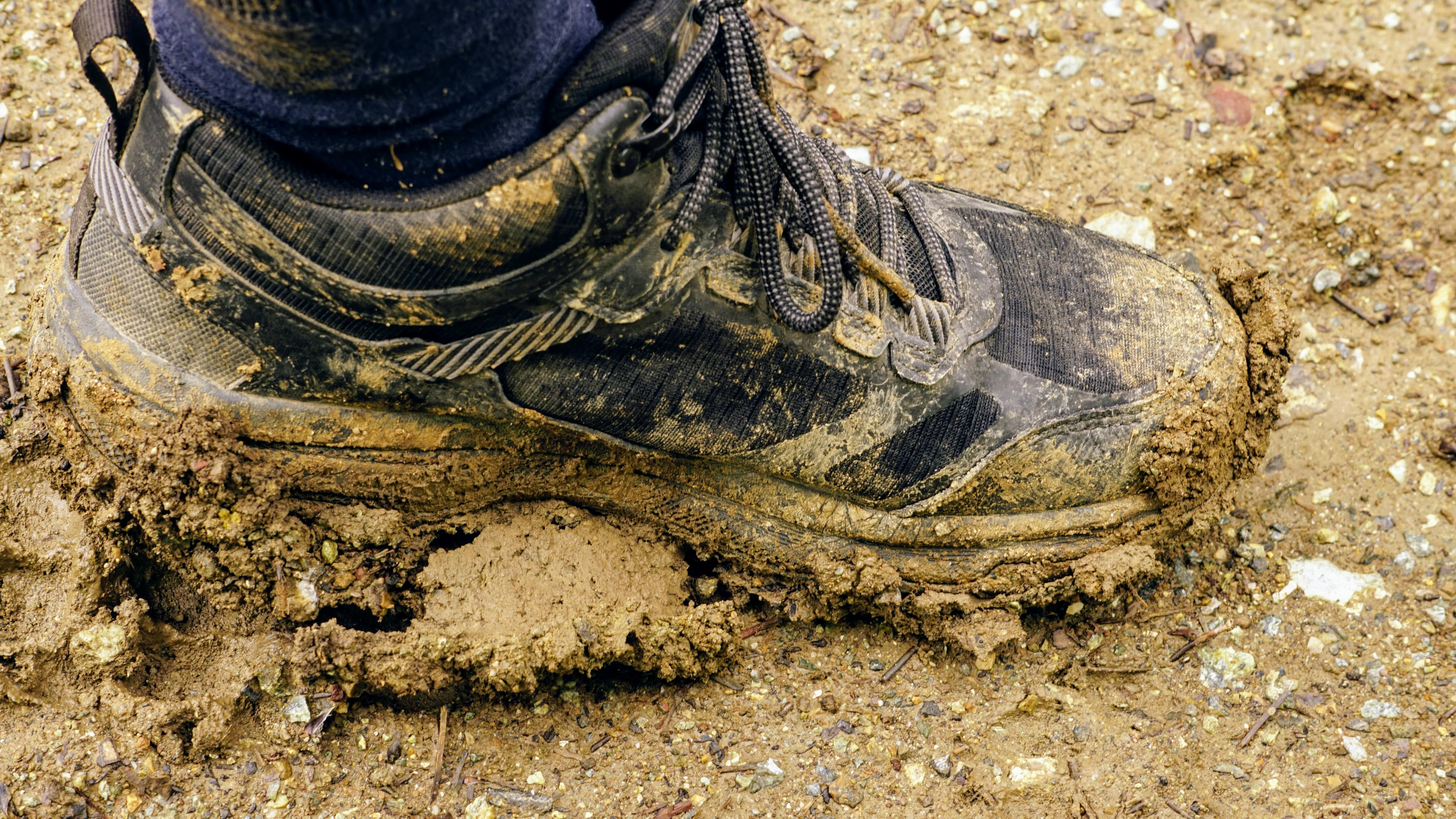 Muddy boot on a dirt trail